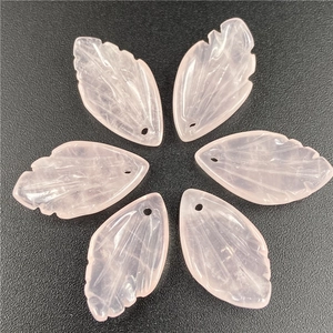 Detailed view of hand-carved rose quartz leaf pendants with delicate vein textures