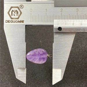 Amethyst leaf pendant with silver bail measured by caliper on a textured background