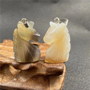 Macro view of hand-carved tiger eye stone unicorn pendants with intricate textures