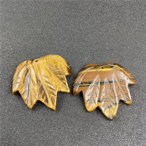Detailed macro view of leaf-shaped Tiger Eye pendants with intricate engraved veins