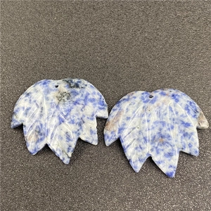 Macro view of blue sodalite leaf-shaped stone pendants with detailed vein carvings