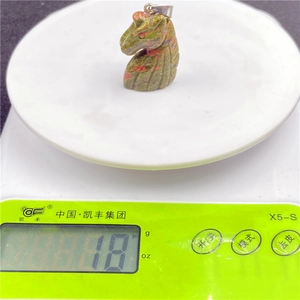 Unakite unicorn pendant weighing 18g shown on digital scale for detailed measurement