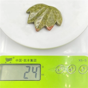 Maple leaf shaped green stone pendant weighing 24g on a digital scale for DIY jewelry