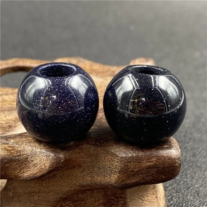 Macro shot of 20mm blue sandstone beads with starlight shimmer for DIY jewelry making