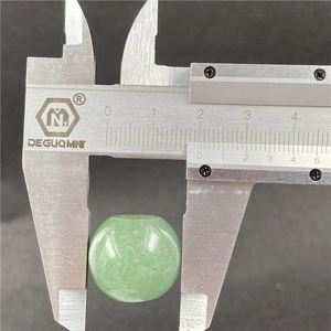 Detailed measurement of a 20mm green aventurine bead showing its size with a caliper