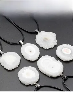 Detail of natural sunflower agate slices with white crystal texture and leather cords