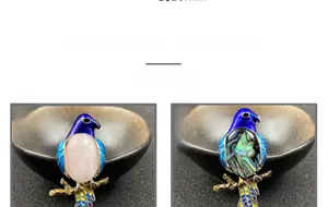 Detailed display of bird brooches with rose quartz, abalone shell, and blue enamel art