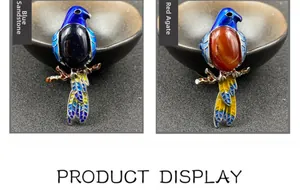 Detail of parrot brooches with blue sand stone and red agate in enamel finish
