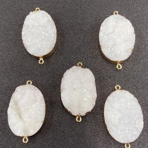 Five oval white druzy crystal pendants with gold-plated edges and double jump rings