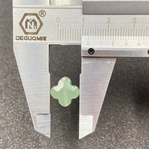 Green Aventurine four-leaf clover loose bead shown with 11mm caliper measurement