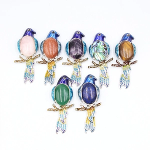 Colorful enamel parrot brooch pendants with assorted gemstones on a white background