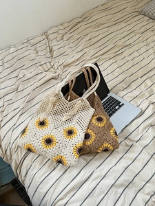 Detailed macro view of crochet sunflower tote bags with intricate cotton mesh weave and tassels