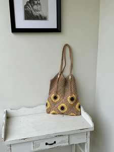 Detailed macro view of handcrafted sunflower crochet tote with vintage cotton tassels
