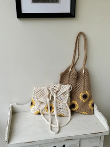Detailed macro view of handmade sunflower crochet patterns on woven cotton beach bags