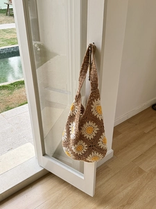 Handmade crochet shoulder bag with daisy patterns for summer beach vacations