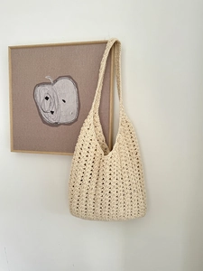 Detailed close-up of ivory crochet tote bag featuring intricate openwork floral patterns