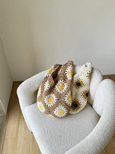 Detailed close-up of handmade crochet tote bags with daisy and sunflower floral patterns
