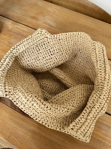 Detail view showing large interior capacity and intricate woven texture of the beach bag