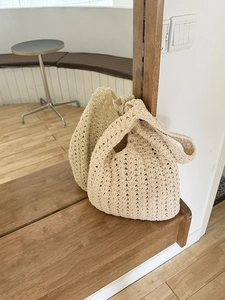 Detail of hand-woven crochet beach tote bag with a minimalist textured hollow knit design