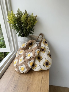 Detail of handmade crochet tote bags with sunflower pattern and knit texture