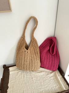 Detail of woven beach bags featuring hollow wave patterns in khaki and magenta colors