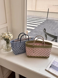 Close-up of handwoven tote bags showing detailed waterproof fiber texture and patterns