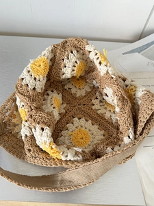 Detail showing the inner lining and sunflower crochet pattern of this handmade straw bag