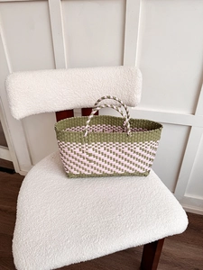 Detailed close-up of the textured woven pattern on the pink and olive tote bag