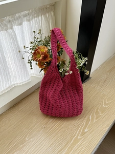 Detailed close-up of rose red hand-woven cotton tote bag featuring V-shaped hollow pattern