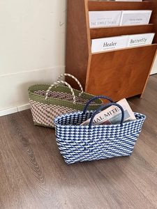 Close-up of dual-color woven tote bags featuring intricate crisscross texture on wood floor