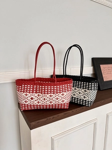 Detail view of woven tote bags in red/white and black/white checkered patterns