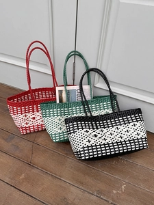 Detailed view of woven beach tote bags in red, green and monochrome checkered patterns