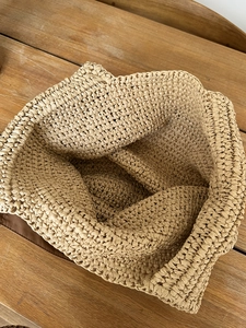Large capacity beige woven straw shoulder bag with durable brown leather base trim