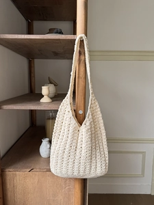 Handcrafted cream crochet shoulder bag with intricate woven texture for beach holidays