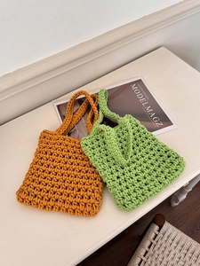 Detail of hand-woven mesh beach bags in ginger yellow and grass green colors