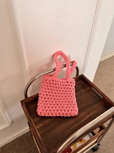 Close-up of pink handmade woven tote bag showing dense thick cotton knitting texture