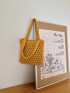 Close-up of yellow crochet pattern and thick cotton texture on this handmade woven beach bag