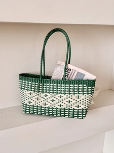 Handmade woven tote bag in green and beige mesh pattern for beach vacations