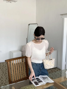 Detailed shot of a woven cream handbag with colorful 3D dots decoration for kids and ladies