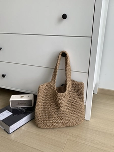 Large beige woven straw tote bag with fine wavy texture for beach or casual summer wear