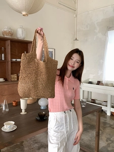 Detail of handwoven straw tote bag showing intricate natural plant fiber texture