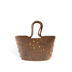 Handwoven cotton thread tote bag with colorful floral accents and round top handles