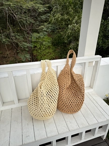 Detailed macro view of handmade hollow-out crochet tote bags in beige and light brown