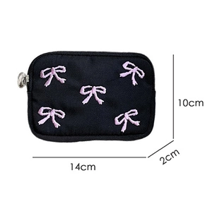 Detail view of small black pouch with pink bow embroidery and 14x10x2cm dimensions