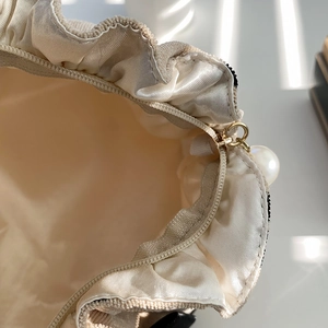 Corduroy cherry makeup bag with ruffle trim and pearl zipper pull on soft inner lining