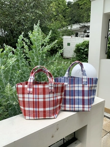 Outdoor close-up of colorful striped canvas tote bags with woven texture and top handles