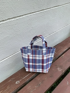 Close-up of red, white, and blue striped canvas tote bag with woven texture detail