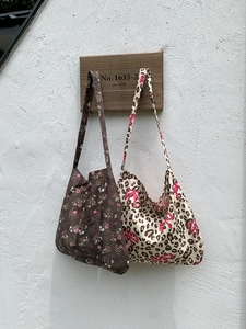 Detailed close-up of large cotton tote bags in floral and leopard bow prints