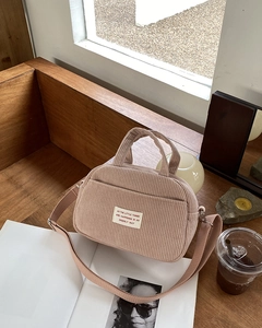 Detailed close-up of pink corduroy bowling bag showing its soft ribbed texture and strap