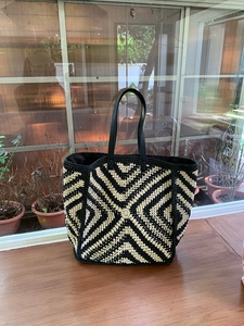 Detailed macro view of the black and white geometric crochet texture on a large tote bag